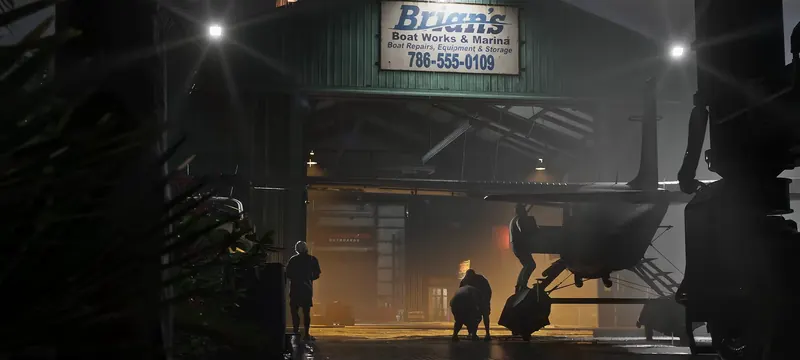 Brian's Boat Works & Marina in GTA VI: Night at Brian's Boat Works & Marina: a seaplane is loaded inside the hangar under the marina's sign.
