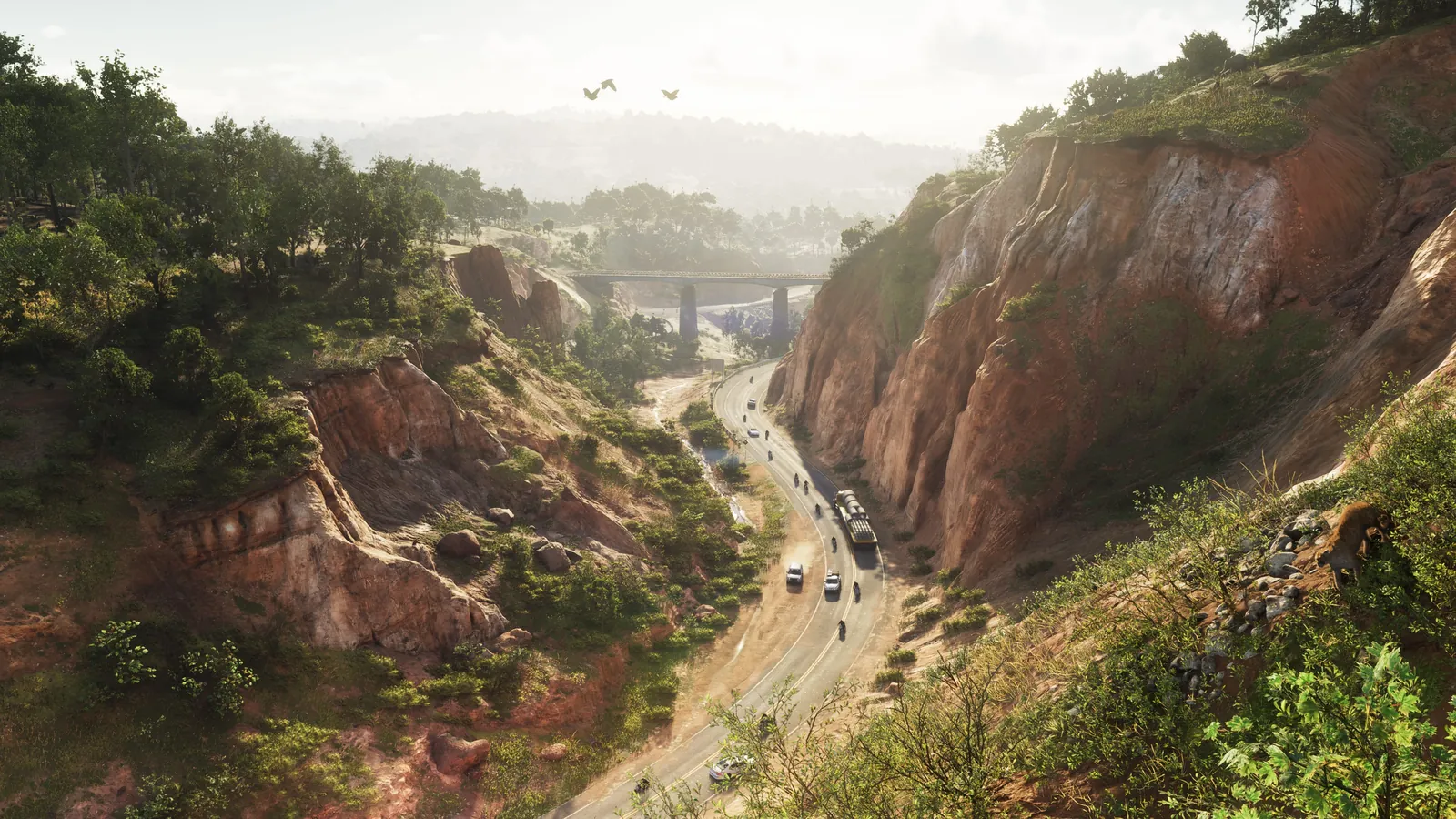 Mount Kalaga National Park in GTA VI: A winding road runs between steep, eroded hillsides topped with greenery in Mount Kalaga National Park.