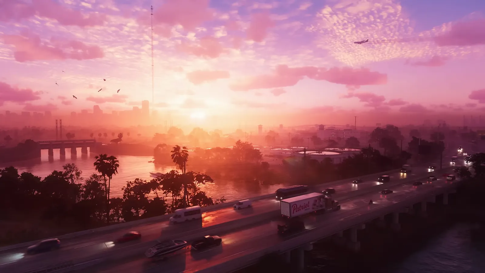 Turkey Point Nuclear Generating Station in GTA VI: Trailer 1's opening sunset view over a river and freeway bridge, with twin power-plant stacks on the hazy left horizon.