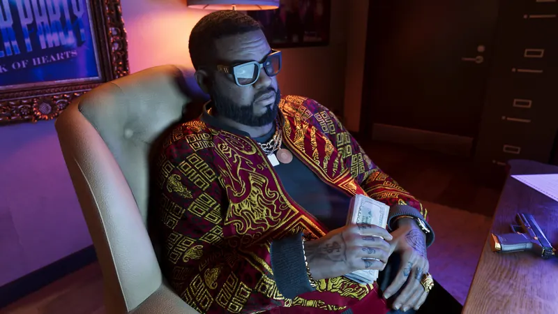 Boobie Ike seated in his office counting cash.