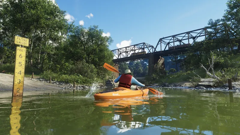 A person wearing a life vest kayaks toward a bridge in Mount Kalaga National Park.